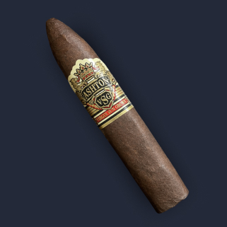 An Ashton VSG Torpedo in Ecuadorian sun-grown wrapper, banded in gold and tan with a crown crest and red stripe.