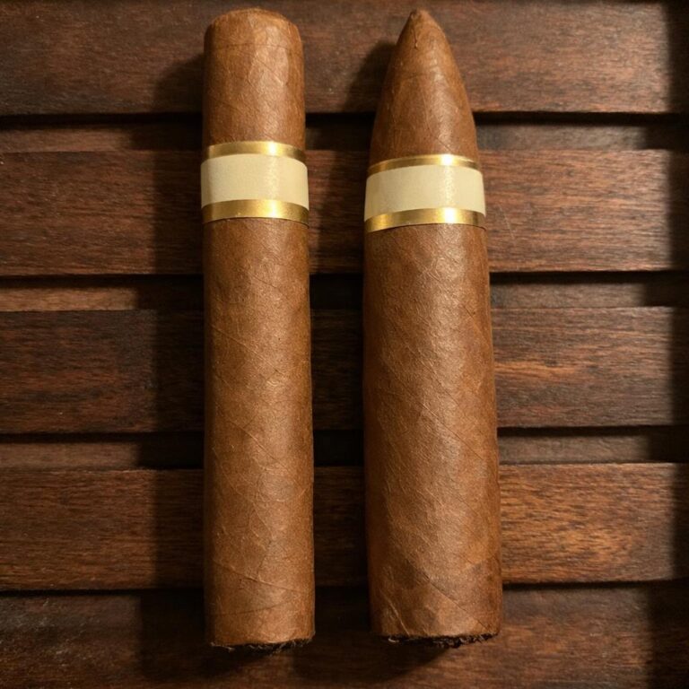 A straight-sided parejo cigar resting beside a tapered pyramid cigar on a cedar tray, showing the two families of cigar shapes side by side.