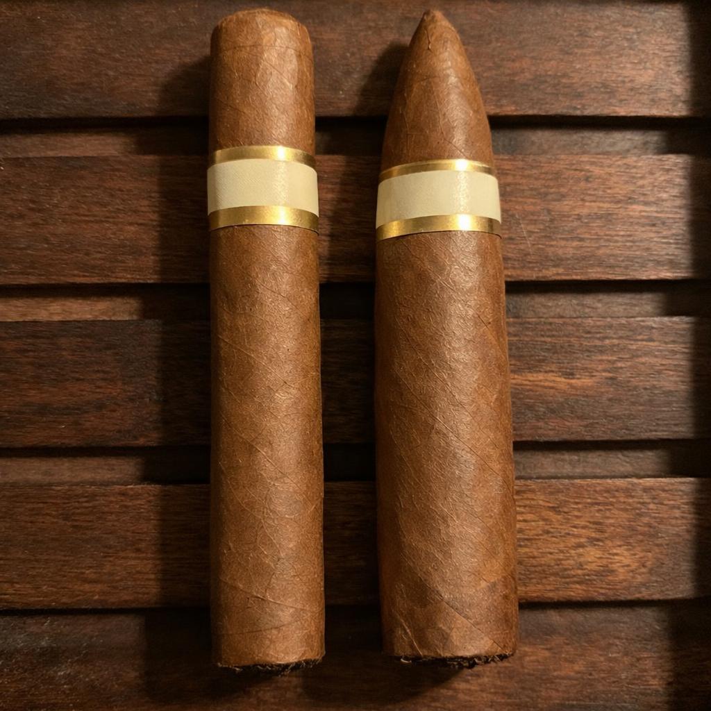 A straight-sided parejo cigar resting beside a tapered pyramid cigar on a cedar tray, showing the two families of cigar shapes side by side.